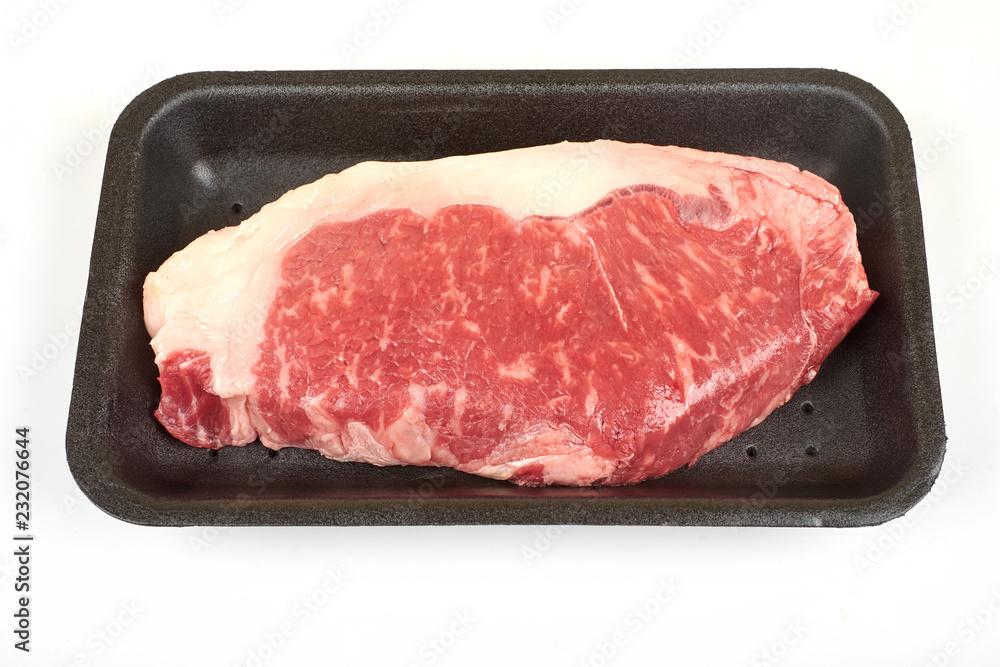 Raw sirloin beef steak in plastic packaging tray. Raw sirloin beef steak in plastic packaging tray.