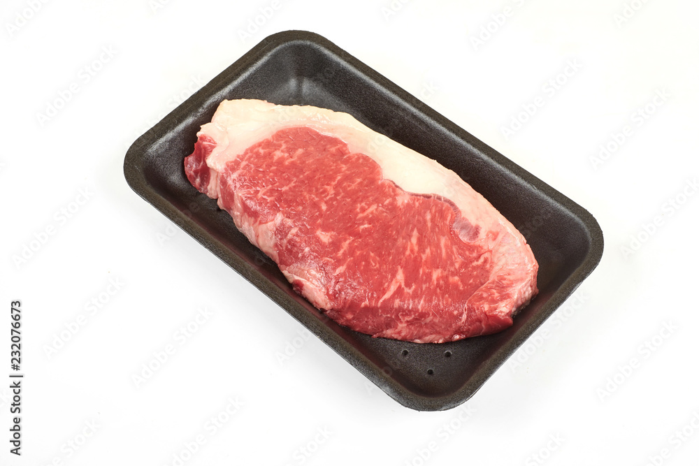Raw sirloin beef steak in plastic packaging tray. Raw sirloin beef steak in plastic packaging tray.