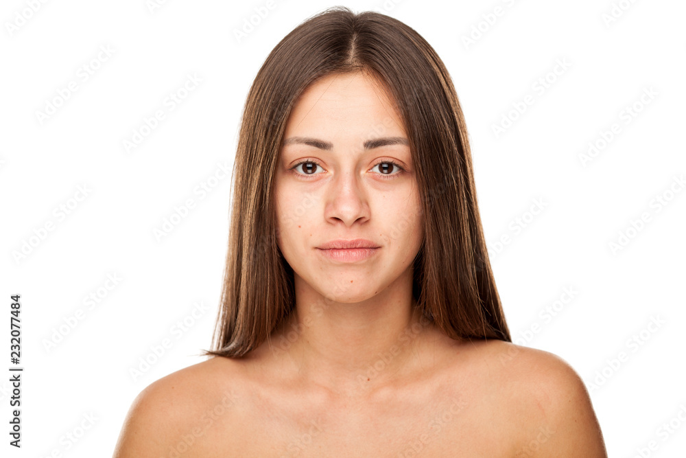 Portrait of young beautiful sad woman with no makeup on white background Portrait of young beautiful sad woman with no makeup on white background