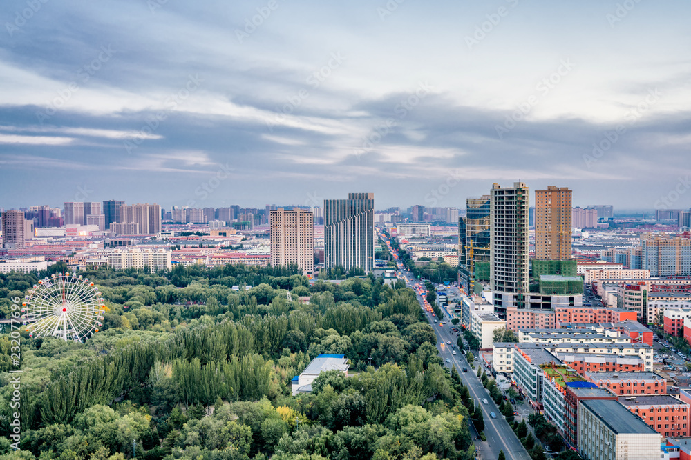 Fototapeta premium Tall view of ferris wheel in qingcheng park, Hohhot, Inner Mongolia, China