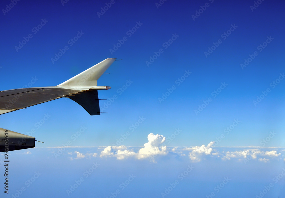 Fototapeta premium Clouds under the airplane's wing