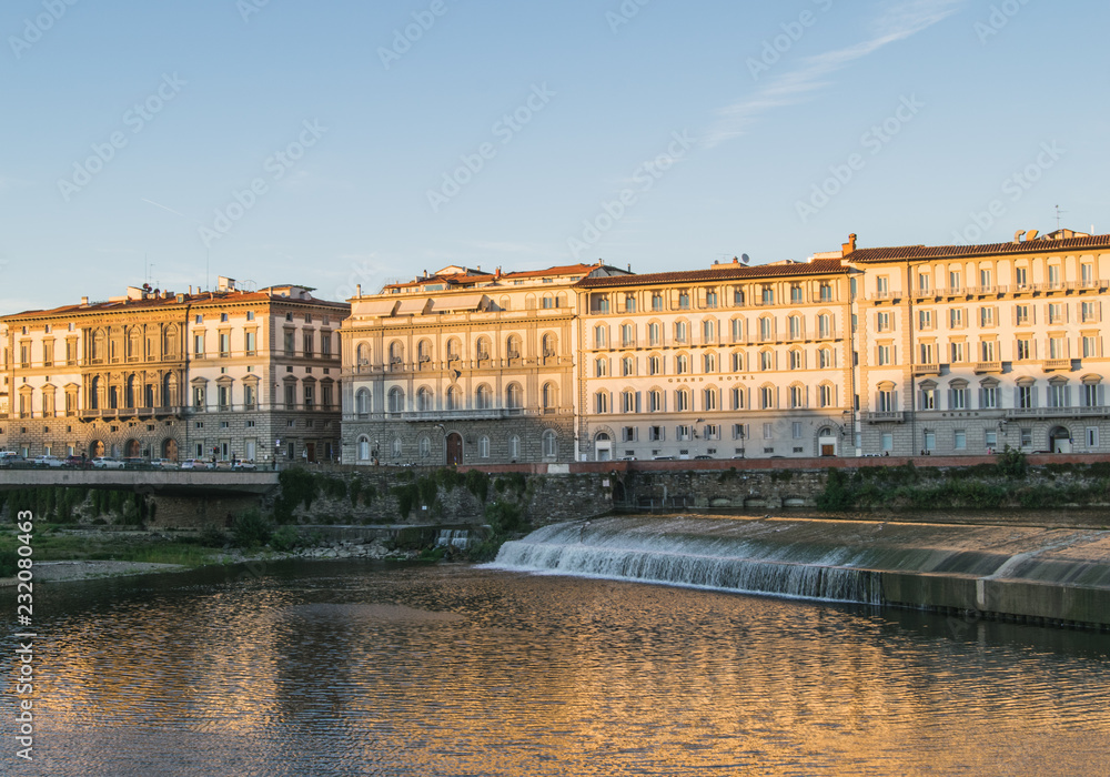 Old dam across the Arno river in Florence, Italy