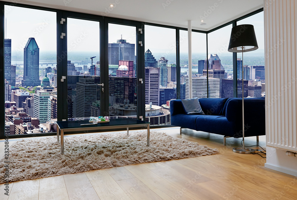 Modern living room with large windows and view on city panorama - obrazy, fototapety, plakaty 