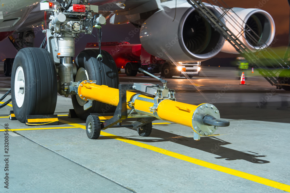 Fototapeta premium Airplane ready for push the back the cart tow tracktor on the front landing gear of the chassis.