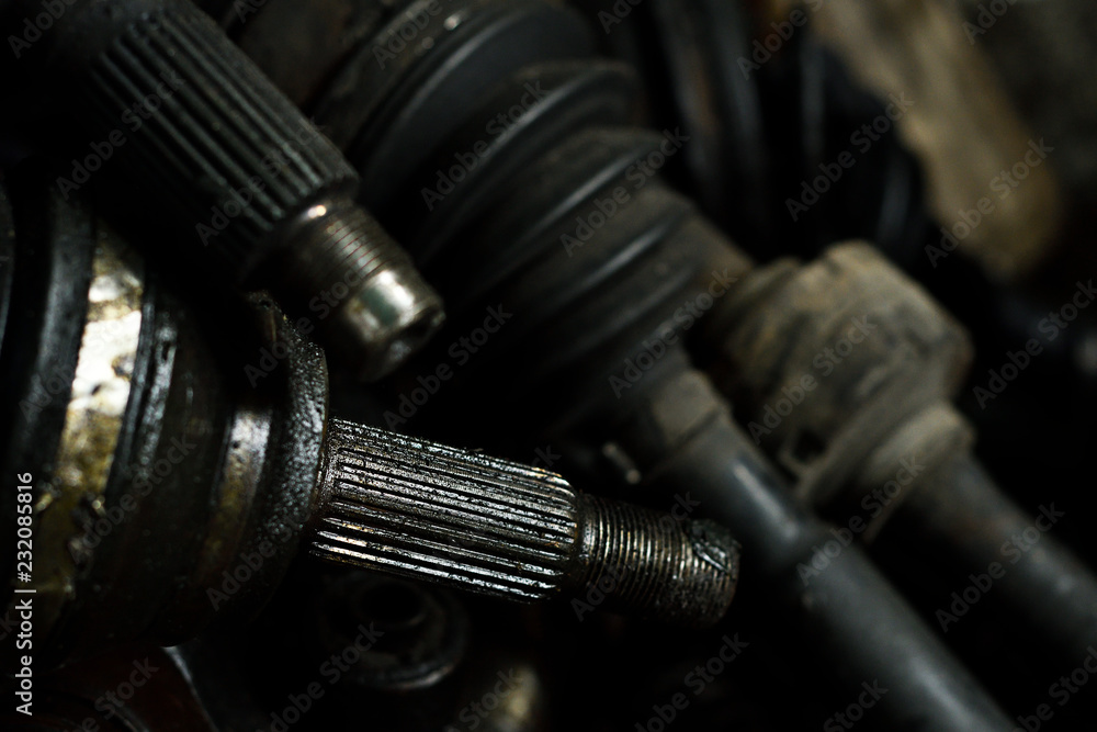 Closeup old and rust drive shaft in garage, drive shaft connecting the gearbox and transmits power to the wheels. Closeup old and rust drive shaft in garage, drive shaft connecting the gearbox and transmits power to the wheels.