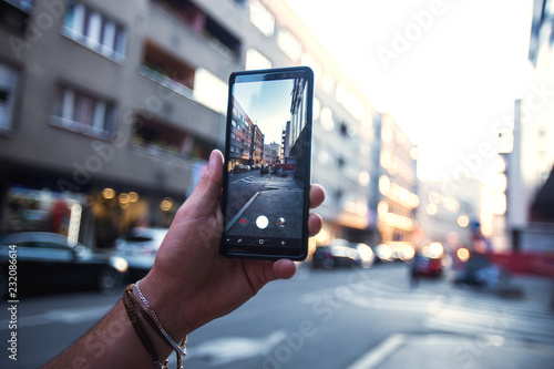 Close-up of hands of young man holding mobile phone