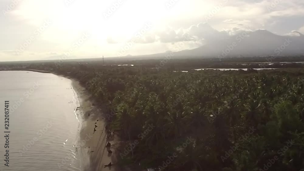 Sun setting over the Empty sandy Beach and Beautiful Calm Sea On Cloudy Day, Drone aerial Sun setting over the Empty sandy Beach and Beautiful Calm Sea On Cloudy Day, Drone aerial