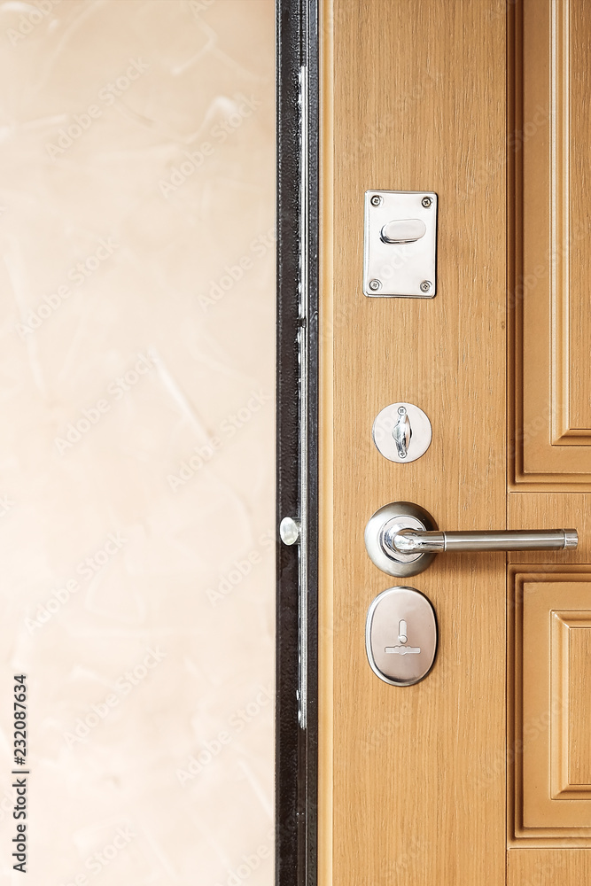 metal door with lock. Modern style door handle on natural wooden door metal door with lock. Modern style door handle on natural wooden door