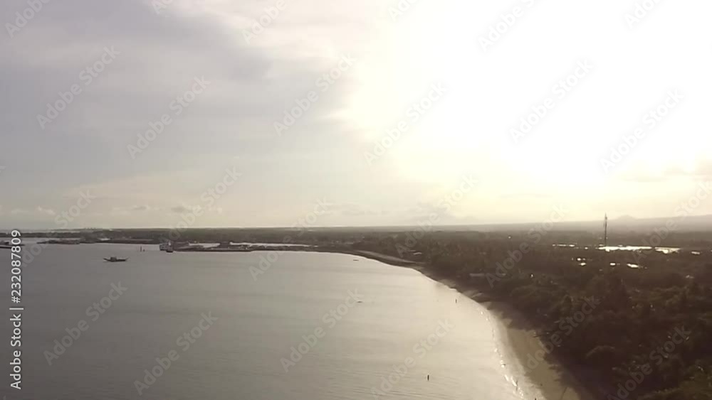 Sun setting over the Empty sandy Beach and Beautiful Calm Sea On Cloudy Day, Drone aerial
