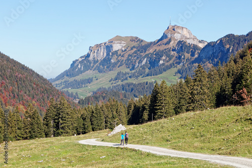 Wallpaper Mural Tourists hiking in sunny, last summer days, Appenzeller Sämtis valley with view of Hoher Kasten cable car station and aerial - Furgglenalp, Alpstein, Appenzell Alps, Switzerland Torontodigital.ca