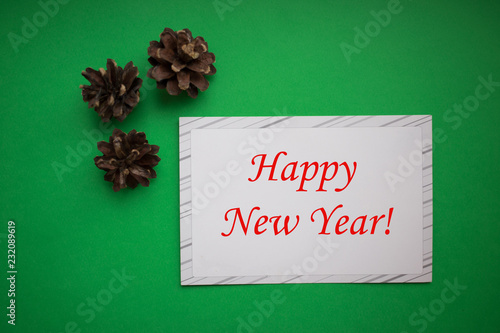 christmas background of pine cones with white paper card. New Year and Merry Christmas Concept