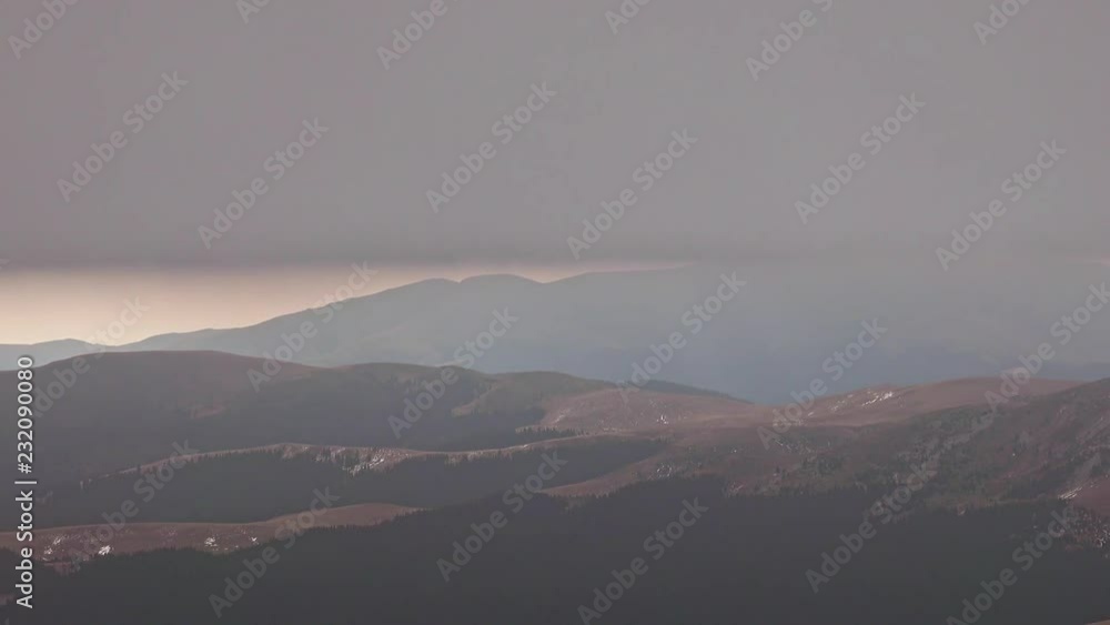 Low clouds over alpine landscape with peaks with snow
Low clouds over alpine landscape with peaks with snow