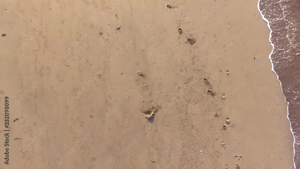 Sand footprints on white sandy beach. aerial shot Sand footprints on white sandy beach. aerial shot