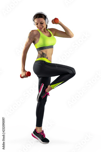 Sporty woman with musculuar torso on a white backgroud. Athletic girl make fitness with dumbbells. Abs fitness woman body. Concept of fitness, healthy fit sexy body.