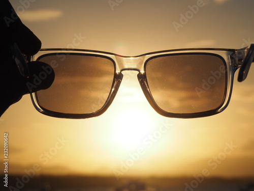 sunglasses on sunset background