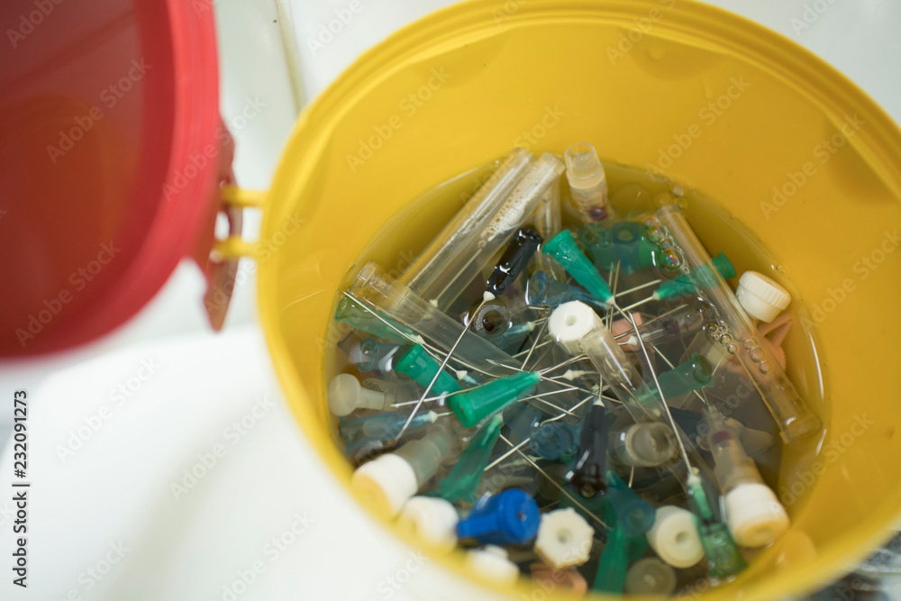 needles and syringes in disinfectant. disposal of medical needles and