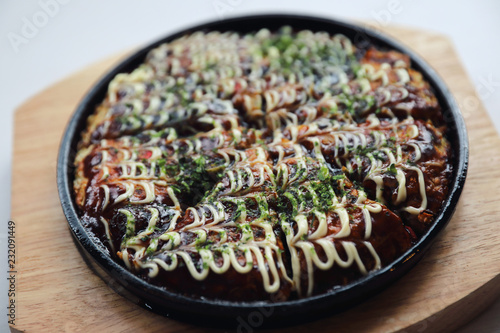 Japanese food okonomiyaki , Japanese pizza on wood plate photo