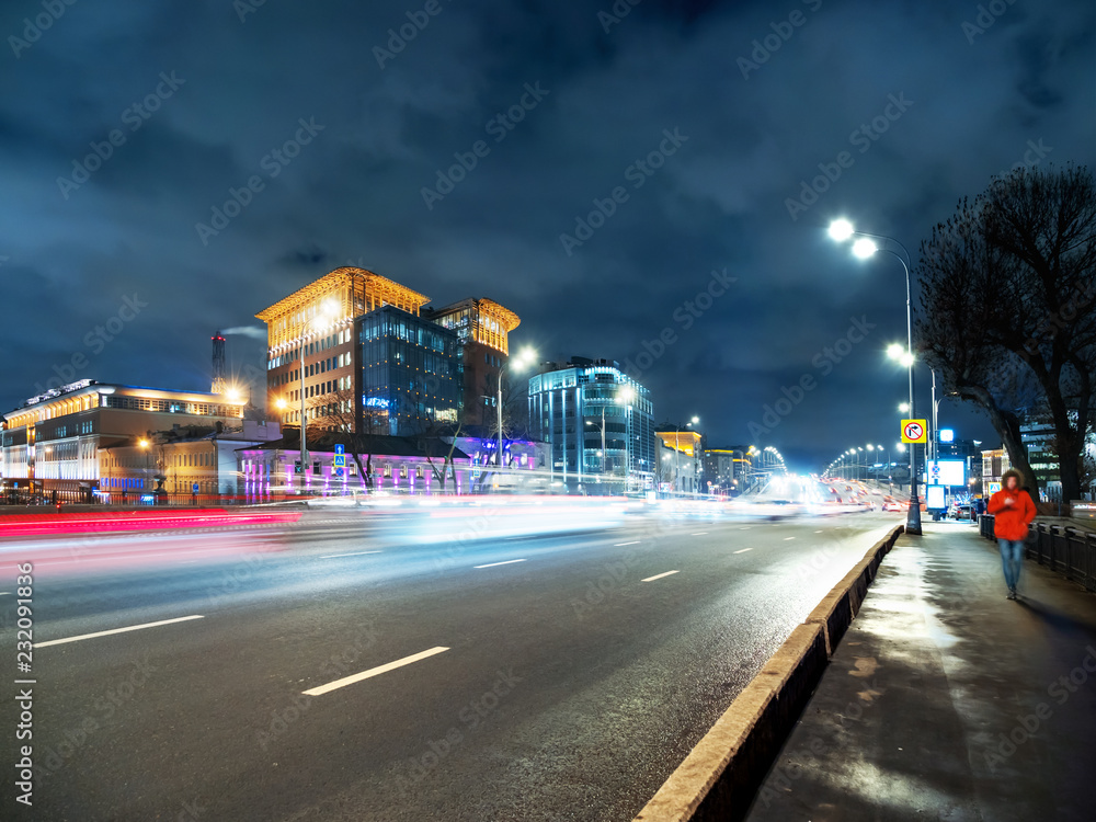 Traffic on Novospasskiy bridge. Night cityscape with moving cars. Moscow, Russia.