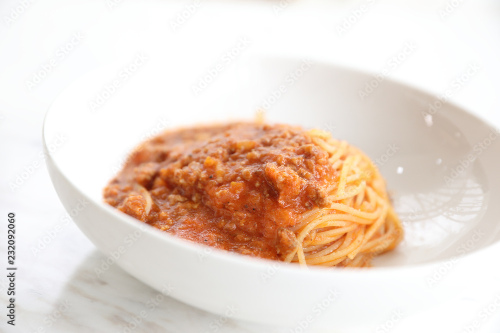 spaghetti Bolognese with minced beef and tomato sauce garnished with parmesan cheese and basil , Italian food spaghetti Bolognese with minced beef and tomato sauce garnished with parmesan cheese and basil , Italian food