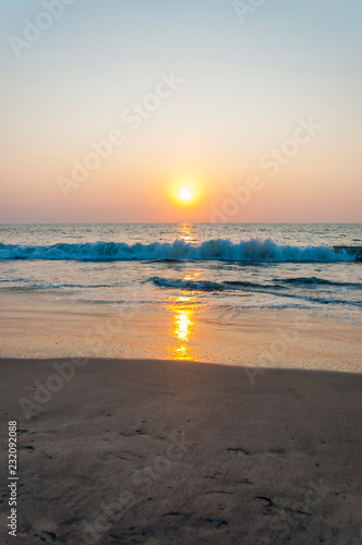 Sunset sun above the Arabian sea beach in Kochi, India.