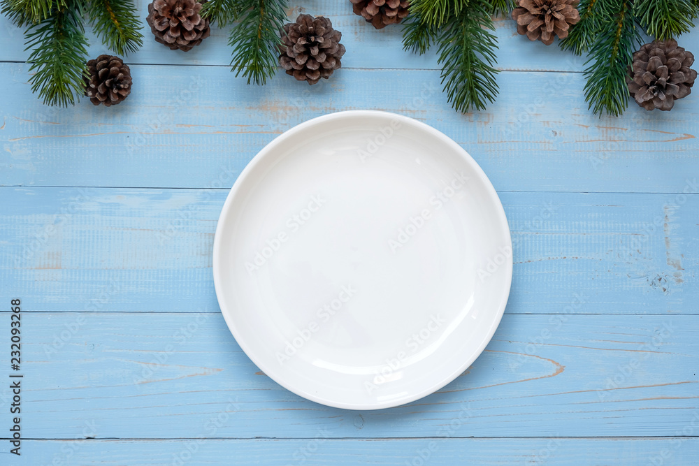 Empty plate with Christmas decoration, preparation for Happy New Year and Xmas Holidays Empty plate with Christmas decoration, preparation for Happy New Year and Xmas Holidays