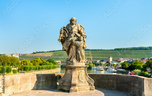 Statue of Saint Joseph with Jesus on Alte Mainbrucke, the old bridge across the Main river in Wurzburg, Germany photo