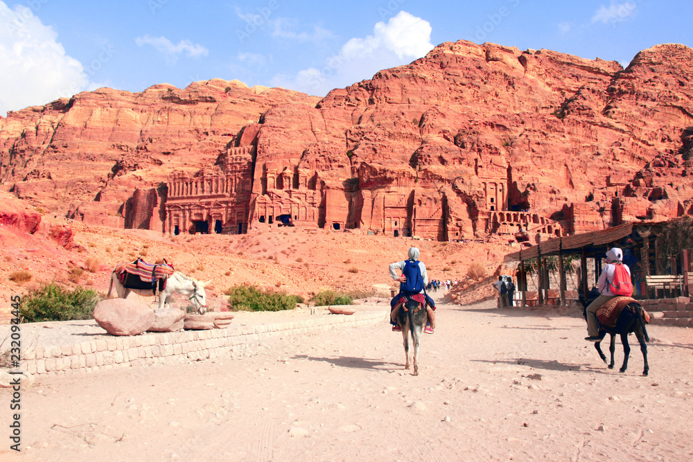 Tourists ride on donkeys in Petra, Jordan Tourists ride on donkeys in Petra, Jordan