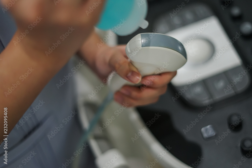 Ultrasonography (USG) hand holding ultrasound probe and coupling gel