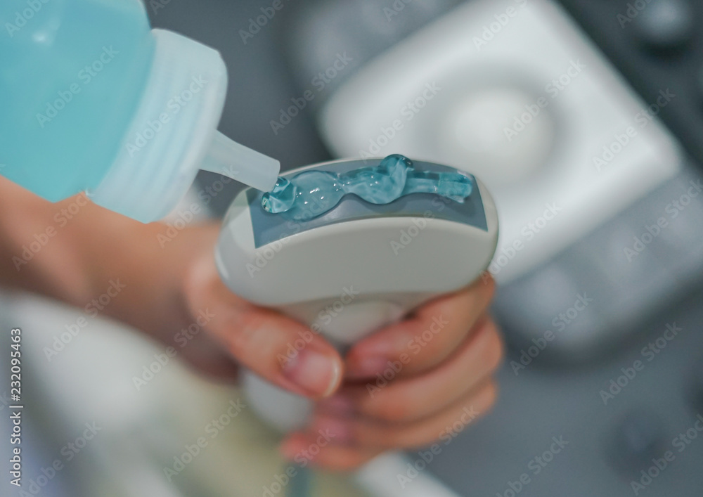 Ultrasonography (USG) hand holding ultrasound probe and coupling gel