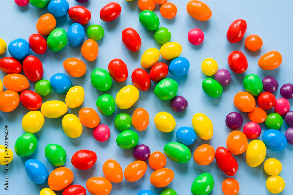 Tasty colorful candies on blue background. Flat lay Tasty colorful candies on blue background. Flat lay