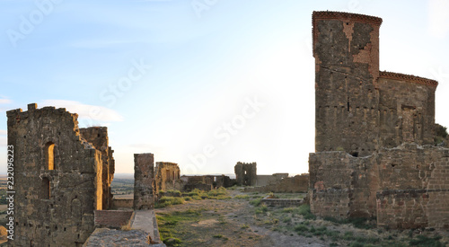 A landscape of the internal square of the abandoned Montearagon castle in the Aragon region, Spain, with a deep blue sky during a summer day