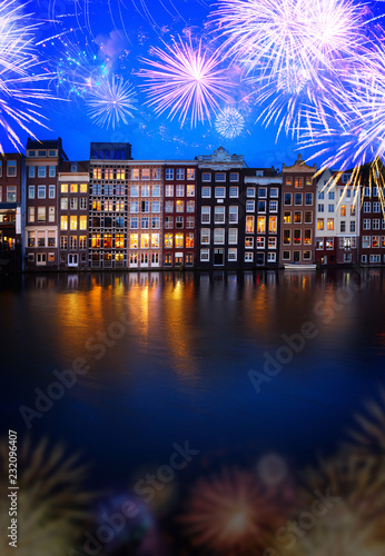 Canvas Print Houses facades over canal with reflections illuminated at blue night with firewo