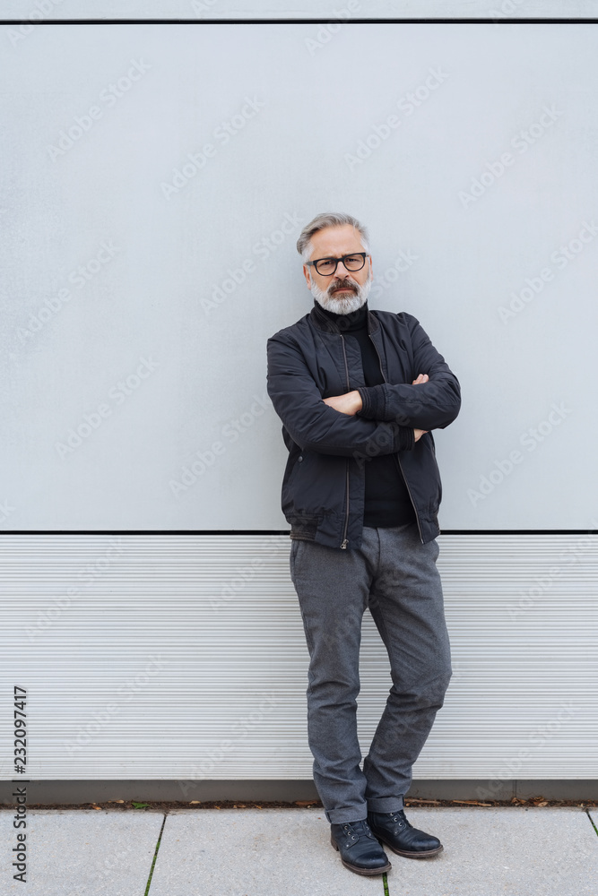 nonchalant man standing leaning against a wall nonchalant man standing leaning against a wall