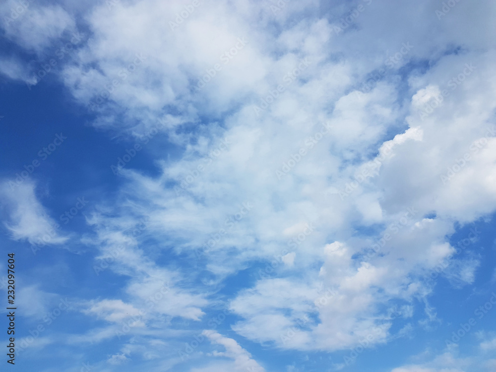 Fototapeta premium Blue sky with white cumulus clouds on a sunny clear day. Natural background for later design. Prediction of weather on the circulation of water in the atmosphere. Heaven is a symbol of holiness