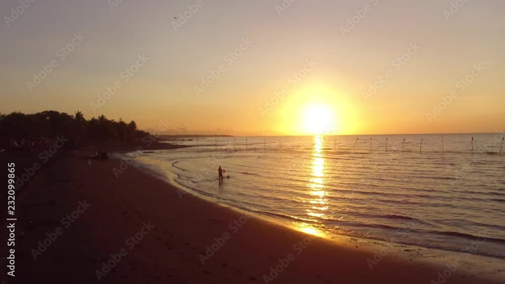 Exotic, romantic view of boat silhouette on a golden sunrise over sea shore. Drone aerial Exotic, romantic view of boat silhouette on a golden sunrise over sea shore. Drone aerial