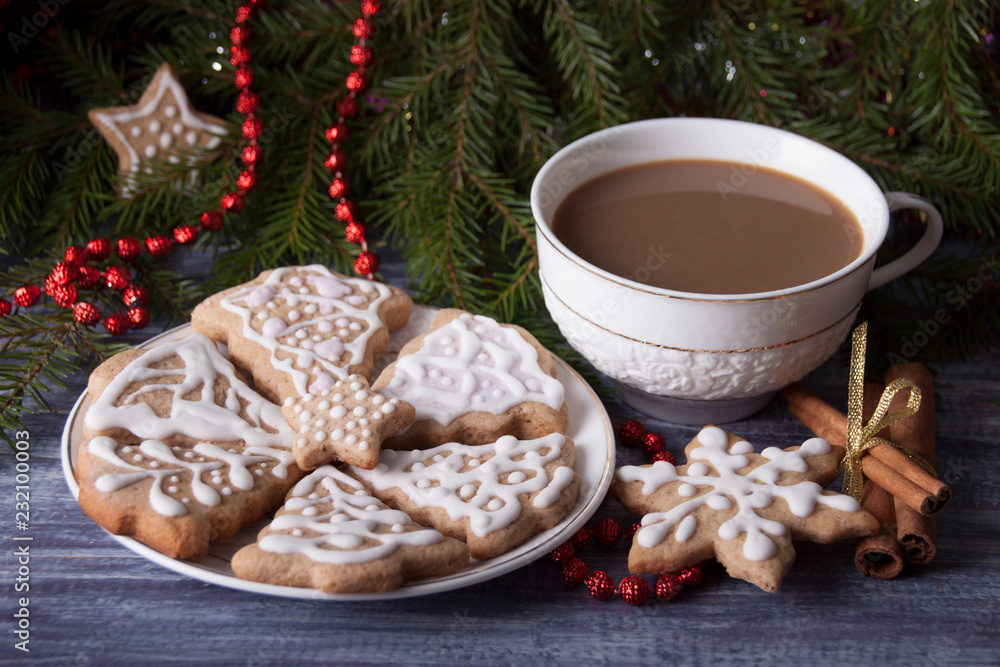 Christmas composition with ginger cookies and a cup of cocoa on the background of spruce branches Christmas composition with ginger cookies and a cup of cocoa on the background of spruce branches