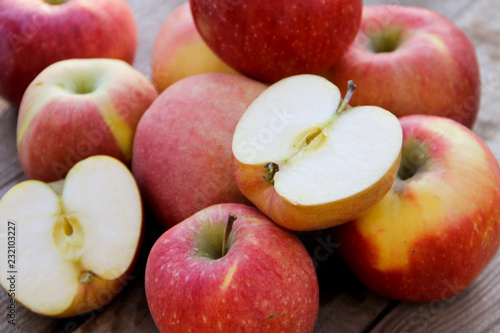 Fresh red apples on wooden table