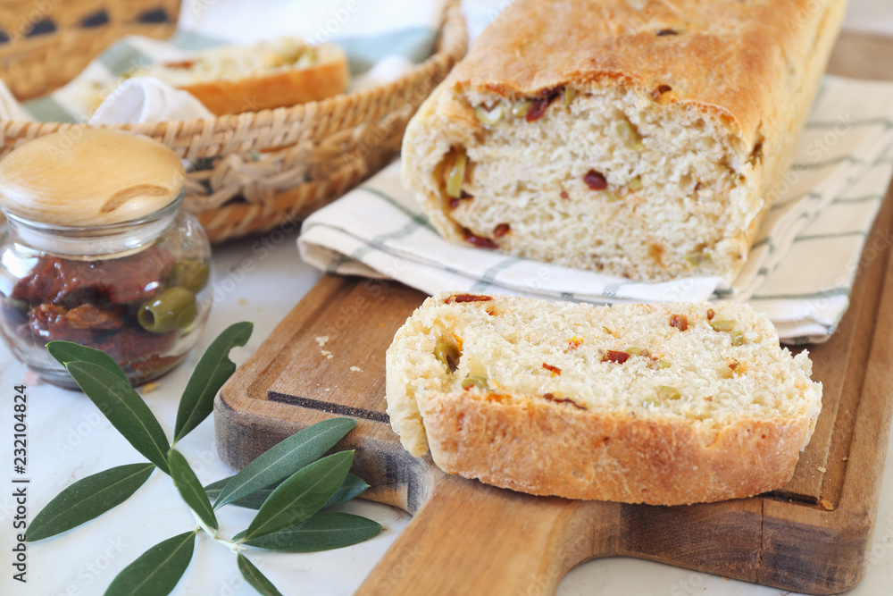 Mediterranean cuisine. Homemade sourdough bread with dried tomatoes and olives