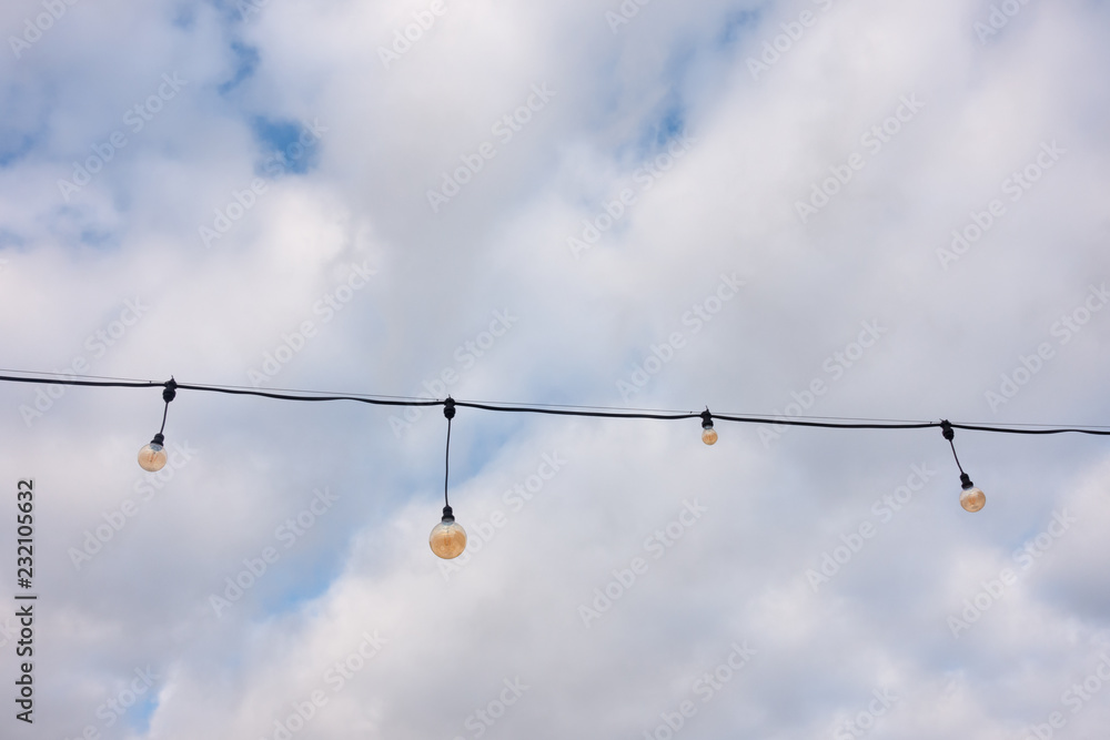 Festive lighting chain against the sky