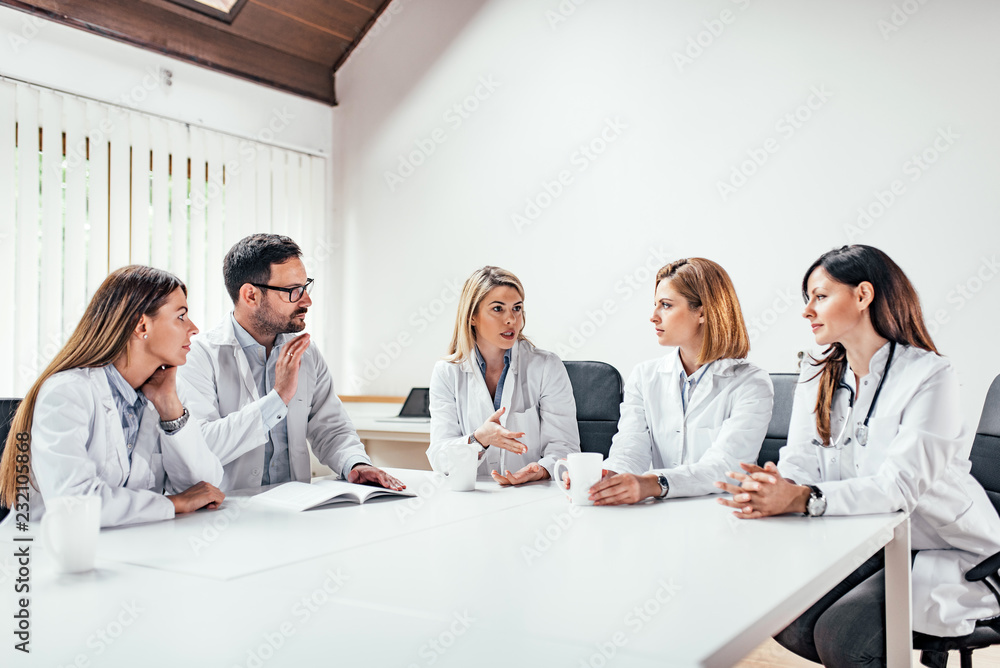 Successful medical doctors discussing diagnosis during the conference.