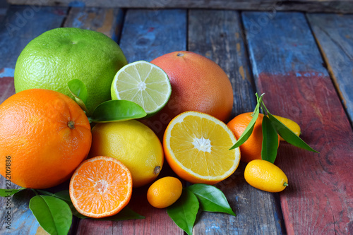 Set of citrus on wooden background  orange  mandarin  lemon  grapefruit  lime  kumquat  tangerine. Fresh organic juicy fruits. Source of vitamin C. Healthy food concept.