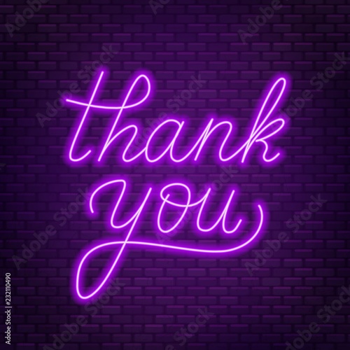 Neon lettering thank you on a dark background.