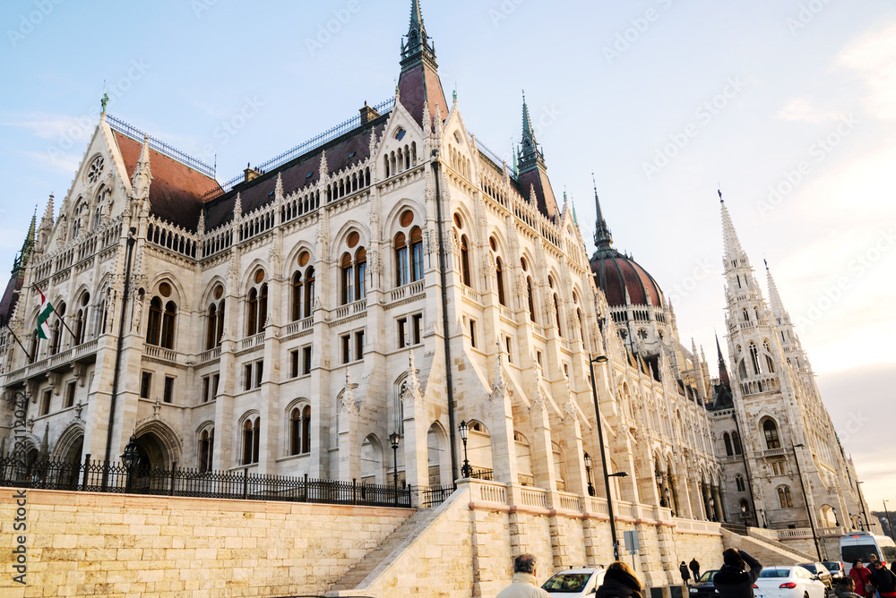 view of historical building of Hungarian Parliament, aka Orszaghaz, with typical symmetrical architecture and central dome on DanubeBudapest, Hungary, Europe