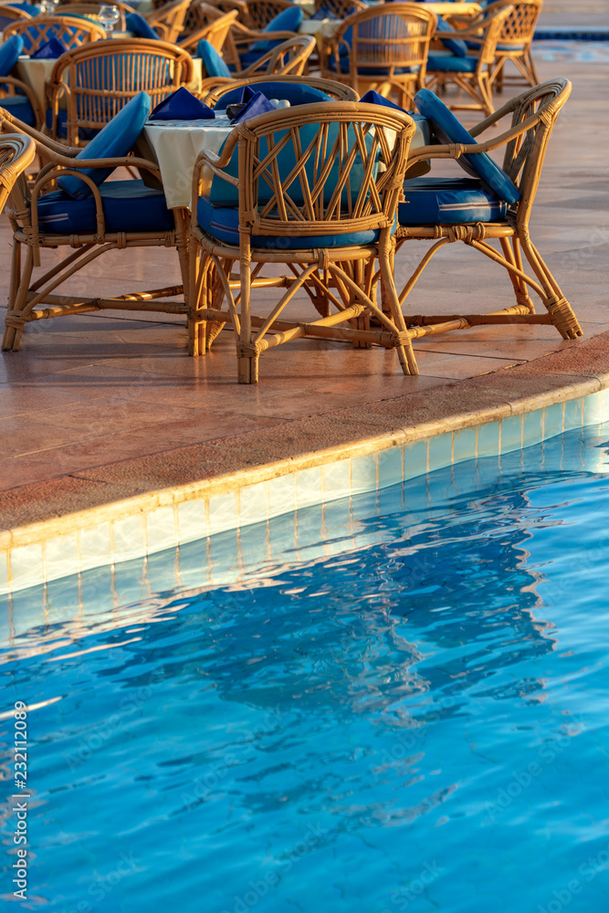 Fototapeta premium Poolside Set Dining Table with Wicker Chairs