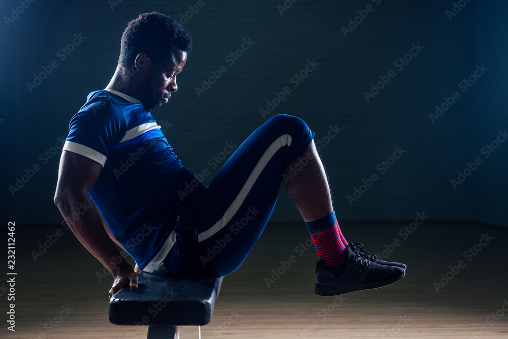Black african american athletic man running on treadmills idoing exercises on muscle groups push up from the bench gym on black background