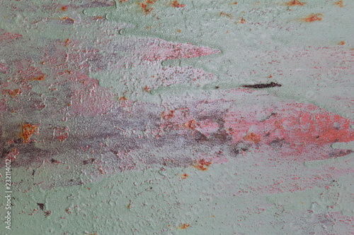 metal rusty sheet with remnants of red and green paint texture