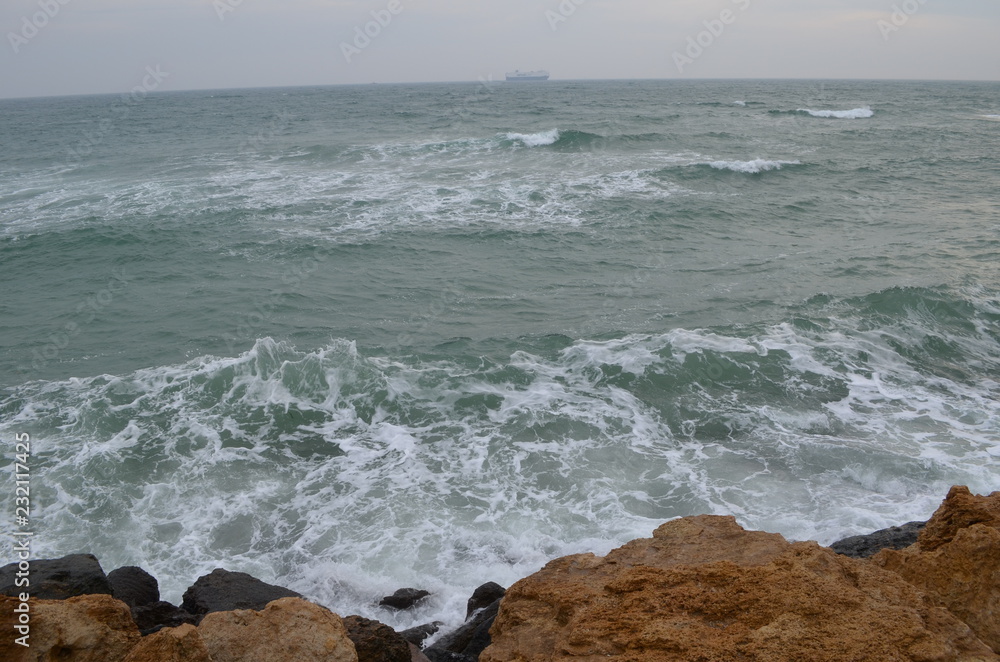 Sea rocks sand waves
