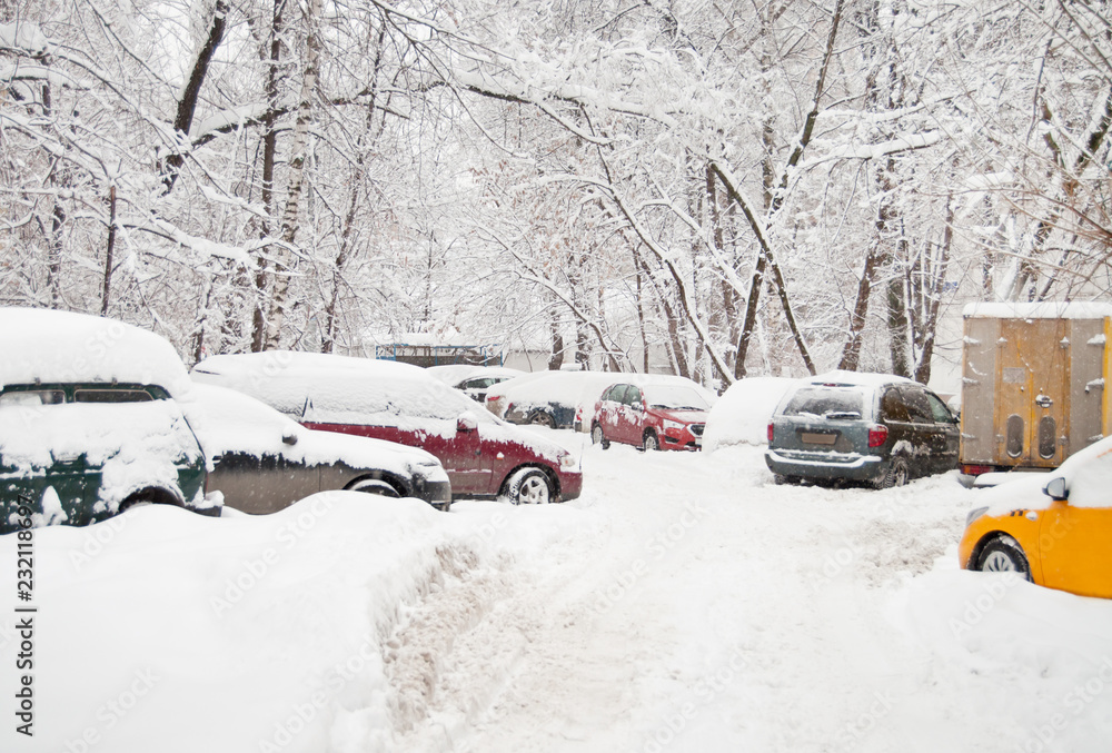 The road in the yard with cars, after a heavy snowfall. The road in the yard with cars, after a heavy snowfall.