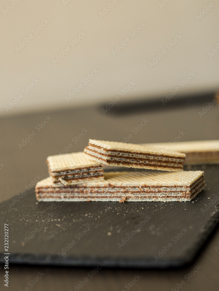Wafers with chocolate on black slate board, close-up Wafers with chocolate on black slate board, close-up