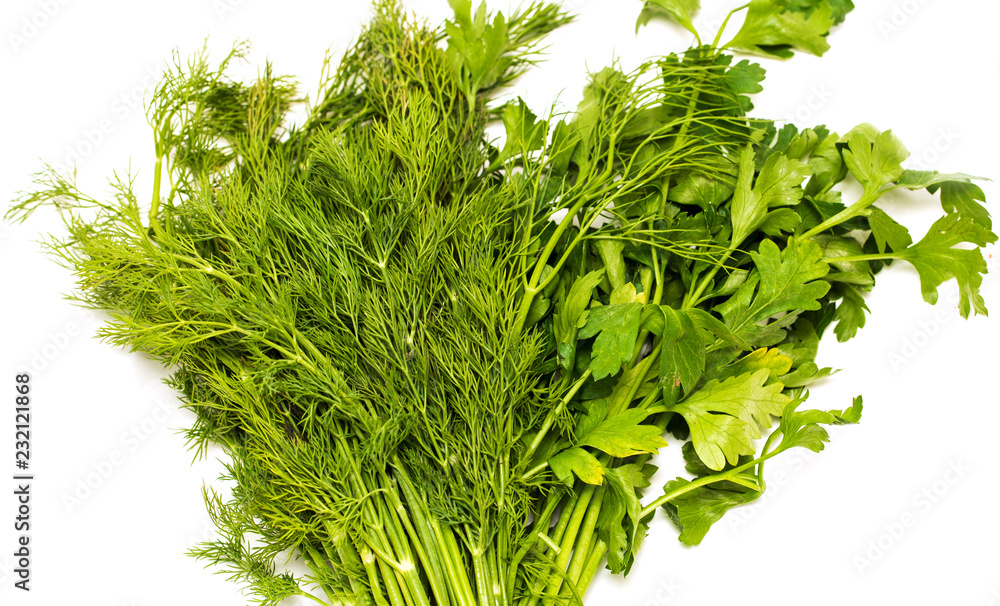 Fototapeta premium Green leaves of dill and parsley on a white background